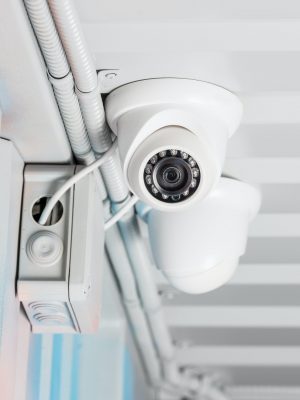 white security camera on ceiling, home security system concept